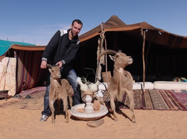 Sofian poses with a Barbary sheep or aoudad at the tourism complex in Taghit.