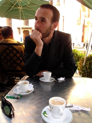 Sofian looks thoughtful. Observe the ever-so-Parisian café where we regularly took espresso and croissant.